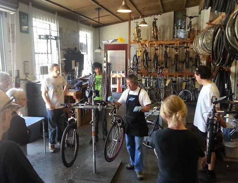 Volunteer teaching a bicycle maintenance class