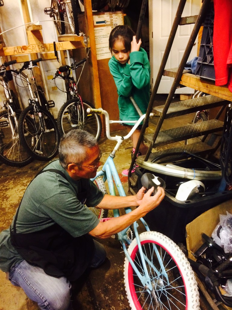 volunteer fixing a bike for a free kid bike giveaway